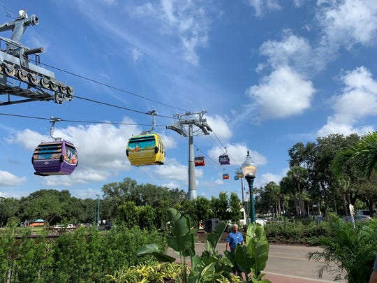 About half of almost 300 Disney Skyliner gondola cars are wrapped with character themes.