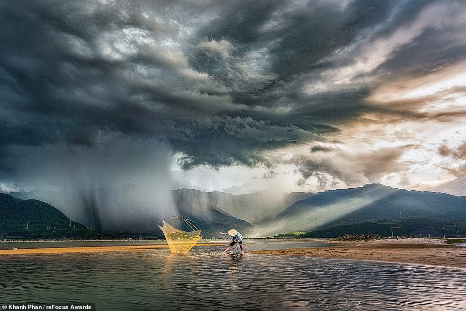 Vietnamese photographer Khanh Phan captured this dramatic picture of a man fishing as a storm approaches, which takes the silver award in the 'People' category for professional photographers