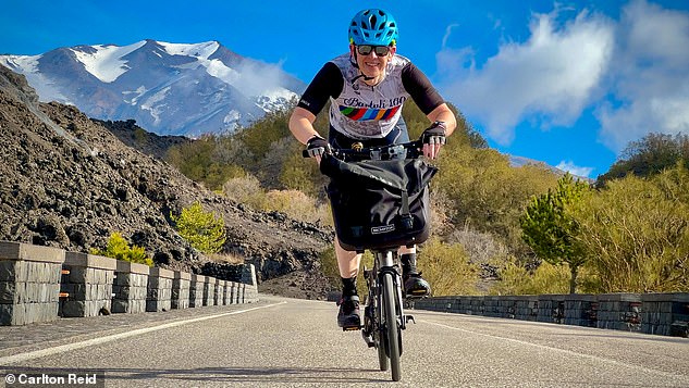 Carlton rose before dawn so he could climb Mt Etna (pictured) on his bike
