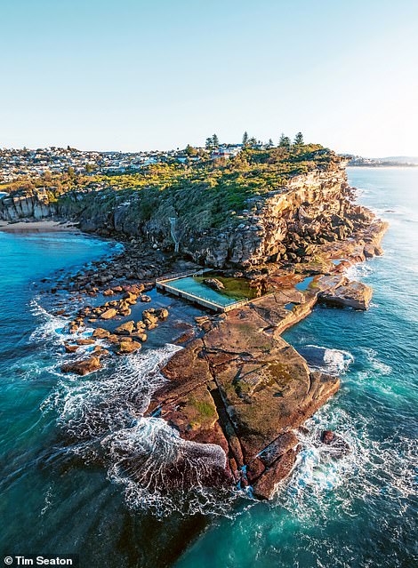 NORTH CURL CURL ROCK POOL, NEW SOUTH WALES, AUSTRALIA: This picture shows one of two pools located on either side of Curl Curl Beach, a long sandy strip nestled in the northern suburbs of Sydney. North Curl Curl Pool is believed to be the only  ocean pool in the area with a rocky outcrop in its centre, writes Romer-Lee. He describes it as 'a particularly wild place'. The author continues: 'Access is only achieved by foot from the headland. The restricted access means the pool is never cleaned; it is at the mercy of nature alone'