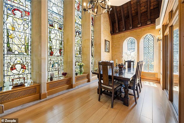 The unusual property boasts double-height stained glass windows overlooking the dining area