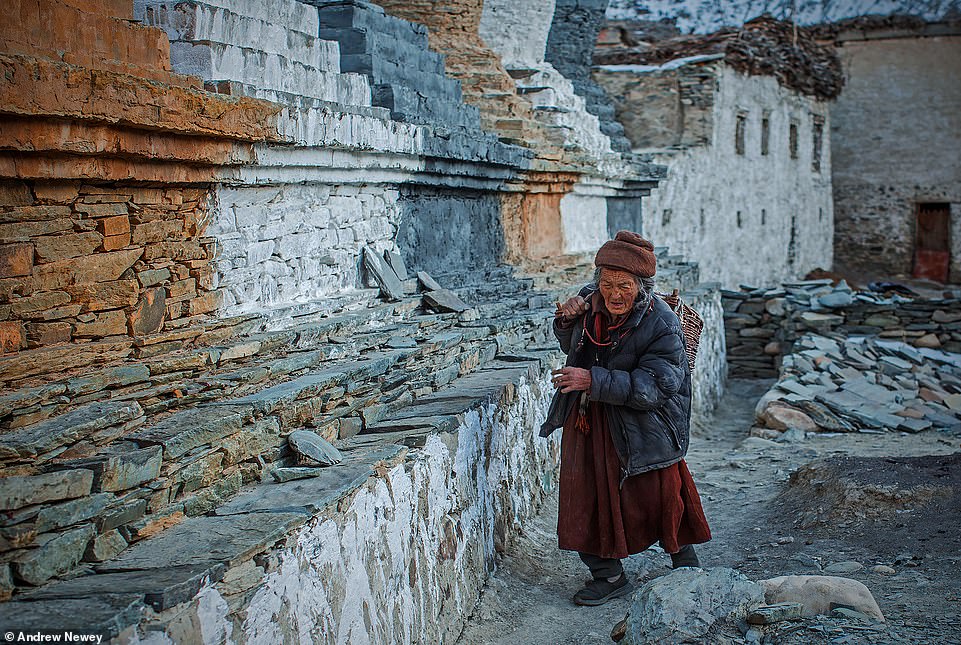 'Buddhism plays a very important part of daily life in the Zanskar Valley,' says Newey. He says that the locals combine prayers with their daily chores. For instance, in this picture, a village elder can be seen walking clockwise around a stupa [a Buddhist monument containing relics] after collecting firewood