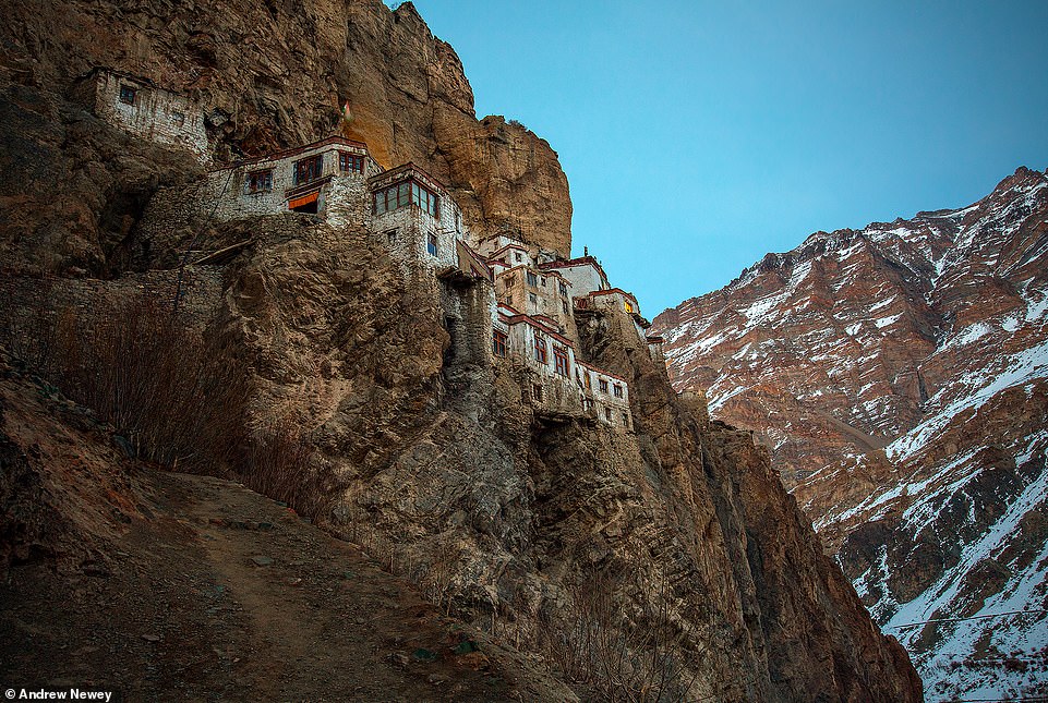 Phugtal Monastery at dusk. Newey says the monastery looks 'like a giant honeycomb clinging to the sheer cliff face' from a distance