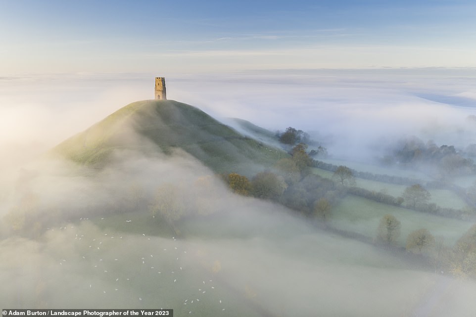 This enchanting image shows Glastonbury Tor in Glastonbury, Somerset, emerging from the morning mist. Taken by Adam Burton, it is highly commended in the Bird's Eye View category