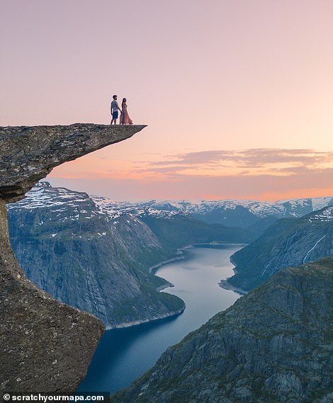 The pair stand atop Trolltunga. One of the most amazing rock formations in Norway, it 'hovers' 700 metres (2,296ft) above Ringedalsvatnet lake