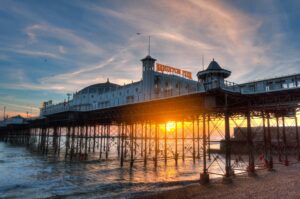 Brighton Pier bathed in golden sunset light during a day trip from London
